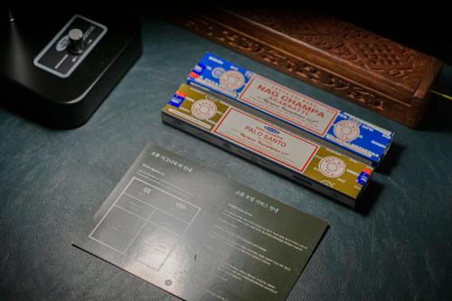 a stack of boarding passes sitting on top of a table at Shourin Hotel Cheonan by Aank in Cheonan