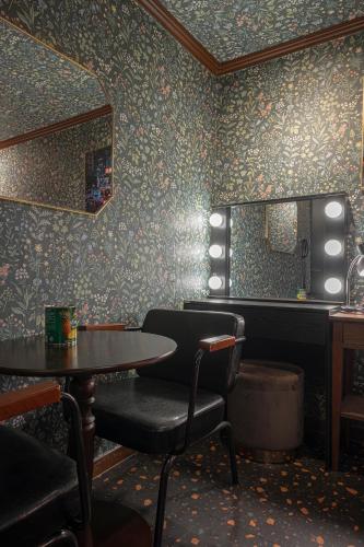 a dining room with a table and chairs and a mirror at Shourin Hotel Cheonan by Aank in Cheonan