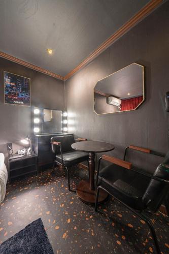 a room with a table and chairs and a mirror at Shourin Hotel Cheonan by Aank in Cheonan
