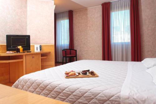 Ein Bett oder Betten in einem Zimmer der Unterkunft Hotel Contà Taste The Experience