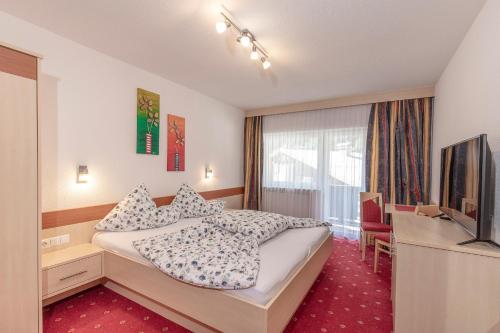 a hotel room with a bed and a television at Apart Felsenhof in Längenfeld