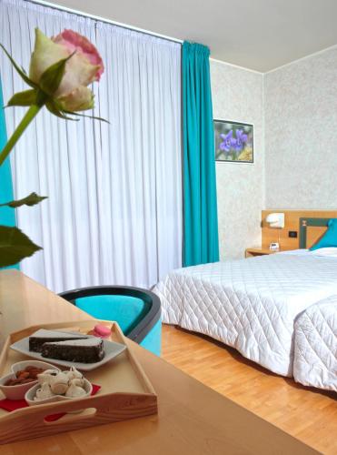 Ein Bett oder Betten in einem Zimmer der Unterkunft Hotel Contà Taste The Experience
