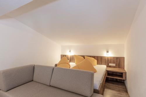 a living room with a bed and a couch at Apart Felsenhof in Längenfeld