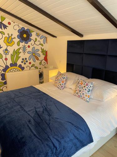 a bedroom with a large bed with two pillows at Osada Parkowa, Kaszuby in Mściszewice
