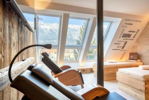 a room with a large window and a room with a bench at Leipziger Hof Innsbruck in Innsbruck