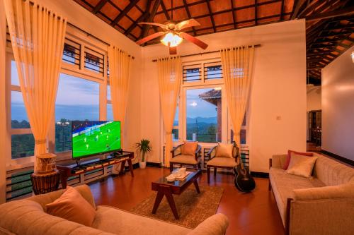a living room with a flat screen tv at Zostel Homes Wayanad (Vythiri) in Wayanad