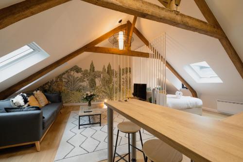 a room with a loft with a couch and a table at L'Entre-Deux Honfleur in Honfleur
