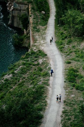 a group of people walking down a dirt road at Langebjerg Pension & Spisested in Allinge