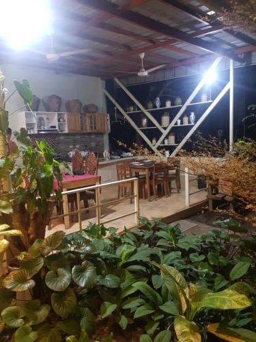 a room filled with lots of plants and tables at B&S pension house in Dipolog