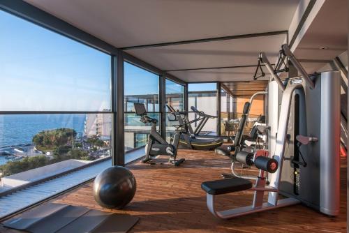 a gym with a view of the ocean at Chania Flair Deluxe Boutique Hotel - Adults Only in Chania