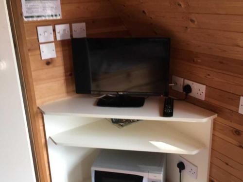 a white desk with a television on top of it at Cartmel Camping Pod in Cartmel