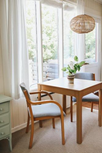 a dining room with a table and chairs and a window at Langebjerg Pension & Spisested in Allinge