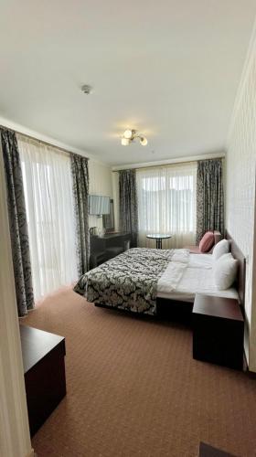 a large bedroom with a bed and a couch at Mountain Lift 7 Hotel in Bukovel