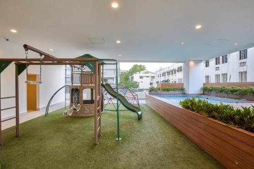 a playground in a building with a pool at Monaco Residences Piantini in Santo Domingo