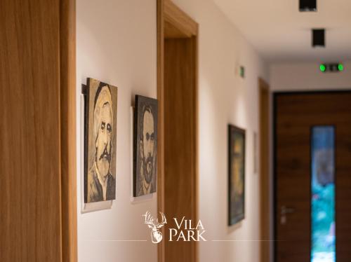 a hallway with four pictures on the wall at Vila Park Bujtina in Prizren