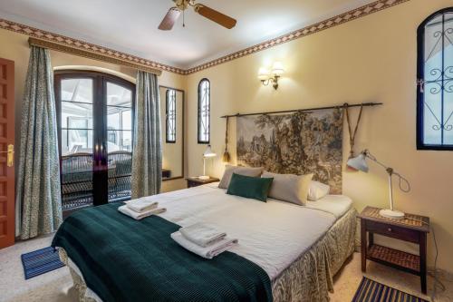 a bedroom with a large bed with towels on it at Villa Nerja Views Mediterranean Panorama in Nerja