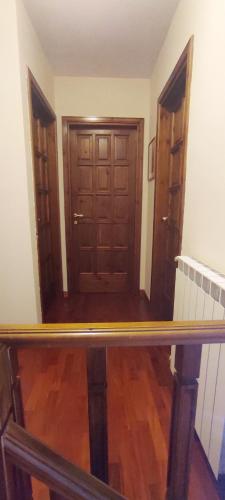 a view of a hallway with a wooden door at Villa Ola in Barrea
