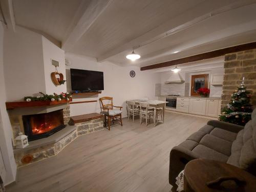 a living room with a christmas tree and a fireplace at Il borghetto in Fanano