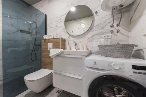 a bathroom with a washing machine and a washer at Villa Lovric in Makarska