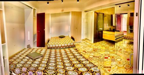 a large room with a bed and a mirror at Apartment Suite residence al porto Vulcano in Vulcano