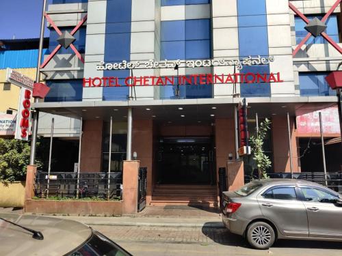 a car parked in front of a building at Hotel Chetan International in Bengaluru