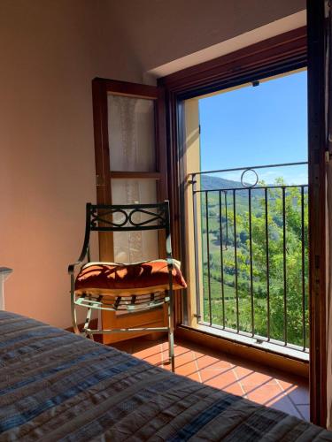 a bedroom with a bed and a large window at Agriturismo i Gessi in Calvignano