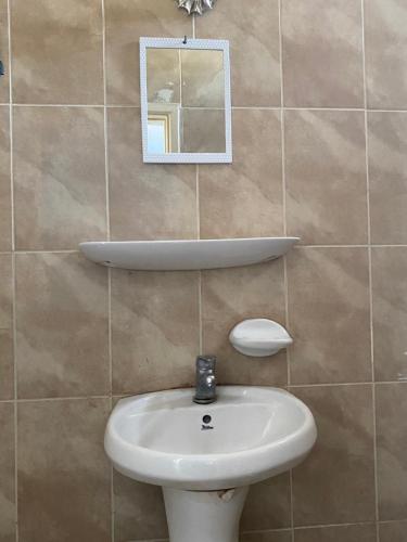 a bathroom with a sink and a mirror on the wall at City Center Hostel in Aqaba