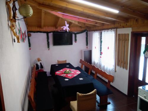 a dining room with a table and a tv at Holiday guest house KEMO in Sapareva Banya