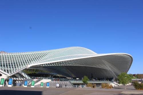 a large building with a curved roof at GUILLEMINS STATION FLATS in Liège