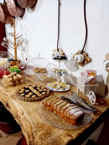 a table with bread and other food on it at B&B Santu Giuvanni "Un tuffo nel passato Fonnese" in Fonni
