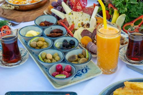 a table with a tray of food and a drink at Porto Amore Club Hotel in Alanya