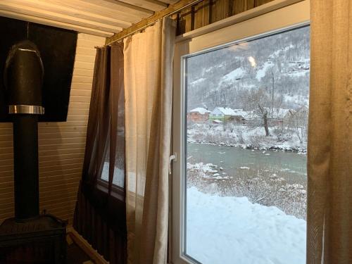 a window with a view of a snow covered river at VIP-Domyk in Rakhiv