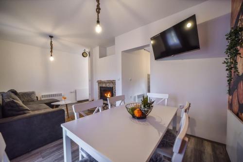 a living room with a white table and a couch at Vila Čarna Zlatibor in Zlatibor
