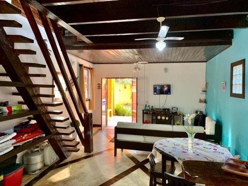 a living room with a couch and a table at Casa na Praia de Maresias in Maresias