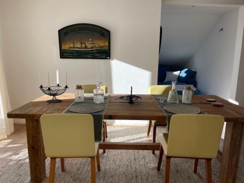 a dining room with a wooden table and chairs at Brig City Mountain View in Brig