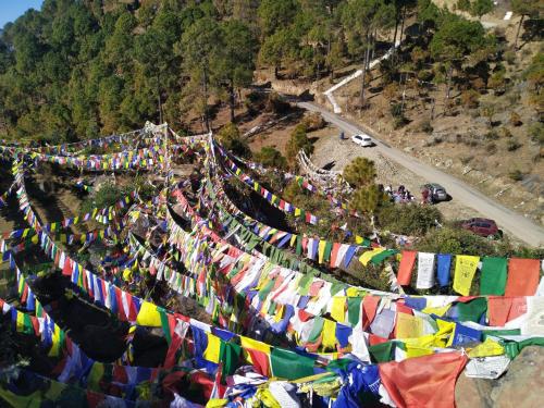 an aerial view of a mountain with prayer flags at Ritu Raj Home Stay & Cafe in Malther