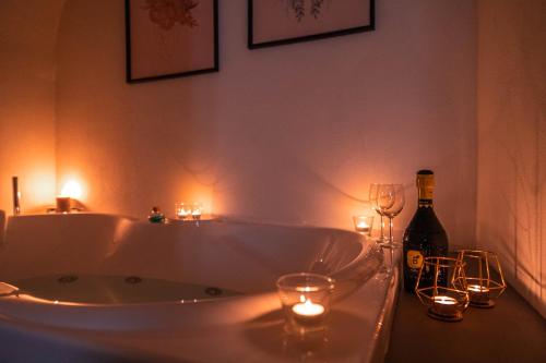 a bathroom with a tub with candles and wine glasses at Albergo Diffuso Monopoli in Monopoli