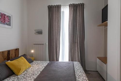 a bedroom with a bed in front of a window at Albergo Diffuso Monopoli in Monopoli