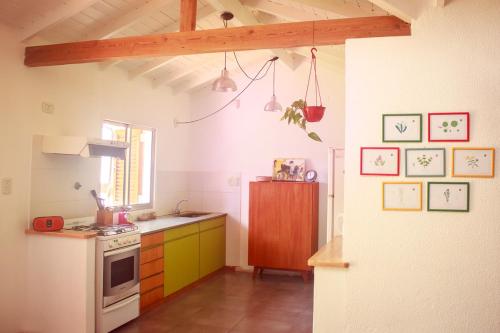 a kitchen with a stove and a refrigerator at Cielo de Tierra in Coronel Suárez