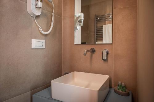 a bathroom with a white sink and a mirror at Albergo Diffuso Monopoli in Monopoli