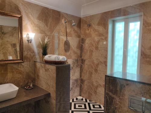a bathroom with a sink and a shower at Dileep Kothi - A Royal Boutique Luxury Suites in Jaipur in Jaipur