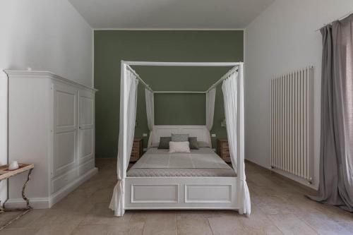 a bed with a canopy in a room at Albergo Diffuso Monopoli in Monopoli