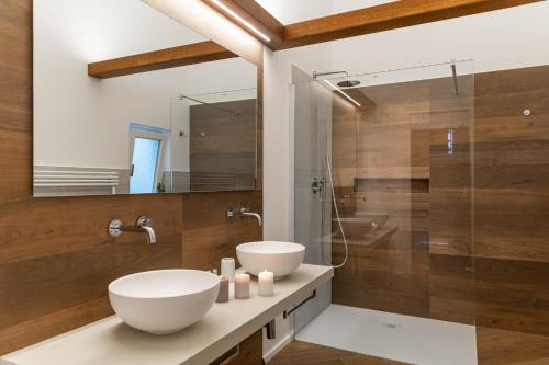 a bathroom with a sink and a glass shower at Albergo Diffuso Monopoli in Monopoli