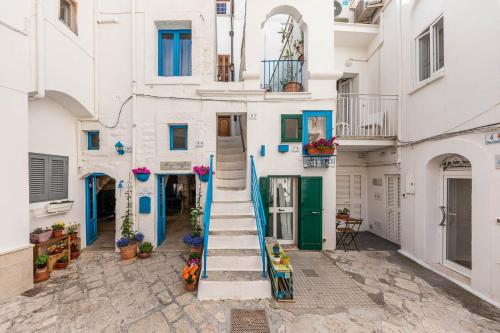 a building with blue and white walls and stairs at Albergo Diffuso Monopoli in Monopoli