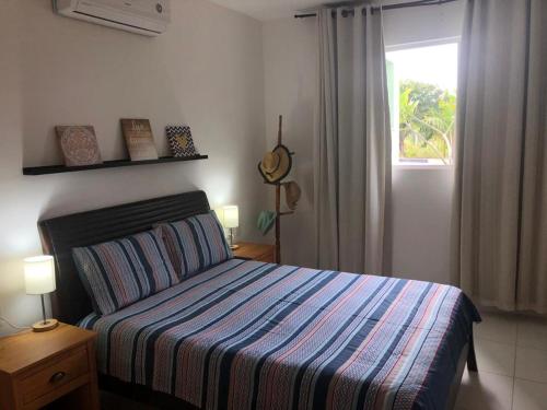 a bedroom with a bed and a window at Reserva Imbassai - Vila dos Lírios - Natureza e Descanso in Imbassai
