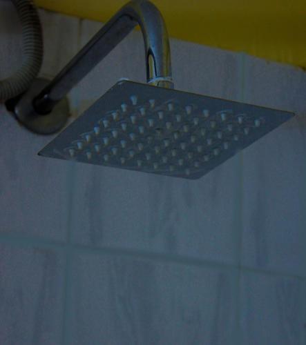 a strainer in a sink in a bathroom at Equator Hotel in Arusha