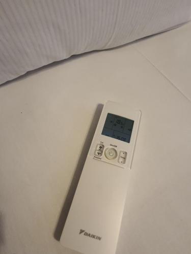 a remote control sitting on top of a bed at Hotel Pension Graf in Konstanz