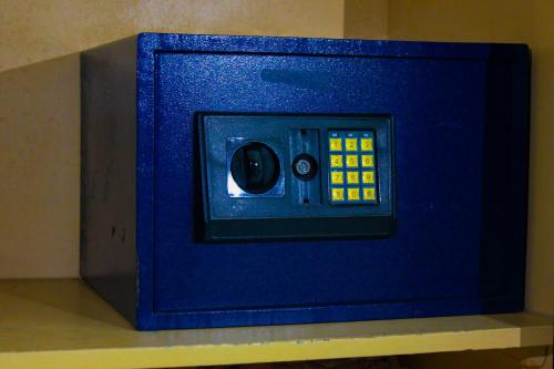 a blue safe sitting on top of a table at Equator Hotel in Arusha