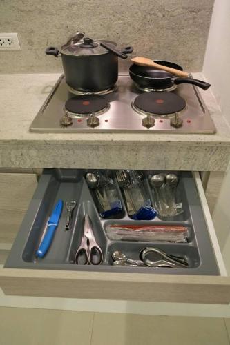 a stove top with a pot on top of it at Chelona 463 Khao Tao Condominium in Khao Tao