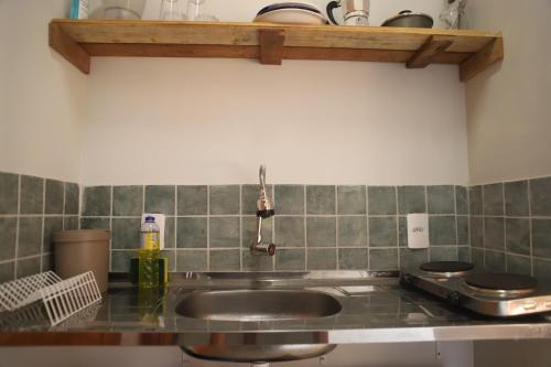 a kitchen with a sink and a counter top at Zero Meia Um Pousada in São Miguel do Gostoso